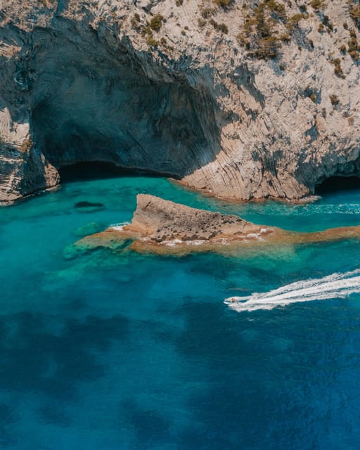 Alcudia: JetSki Tour Coll Baix beach & Caves (free Photos) - Alcanada lighthouse island: an easy photo stop