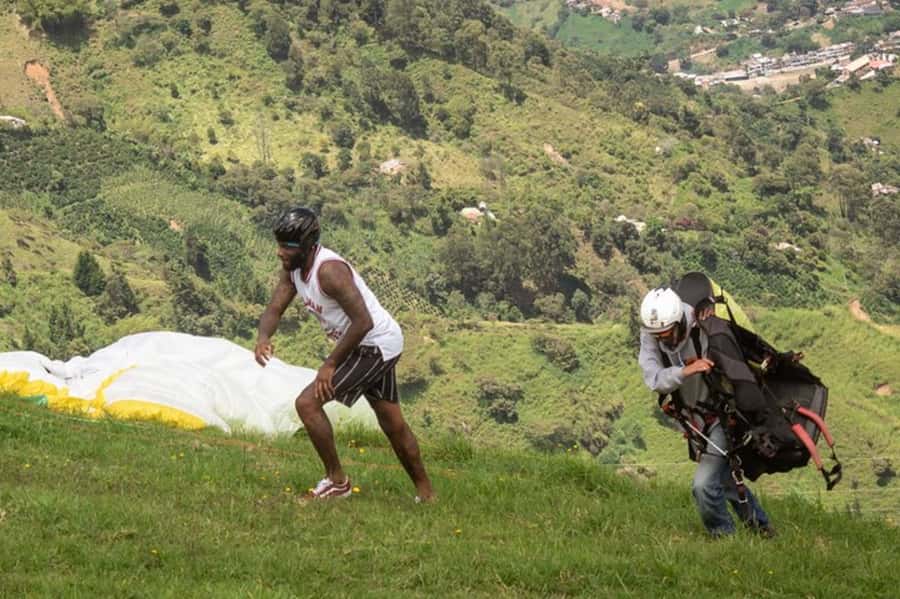 From Medellín: Paragliding Tour with GoPro Photos & Videos - Cancellation and language details